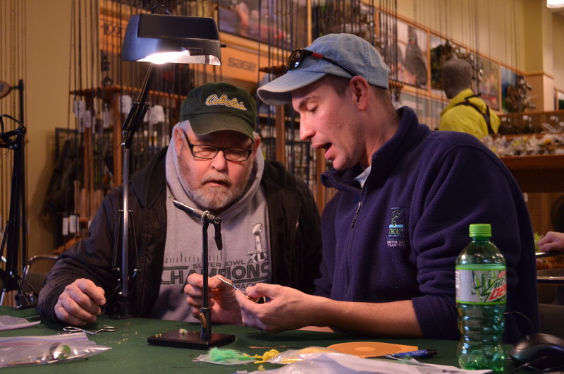 Adrian showing his fly tying customer the materials