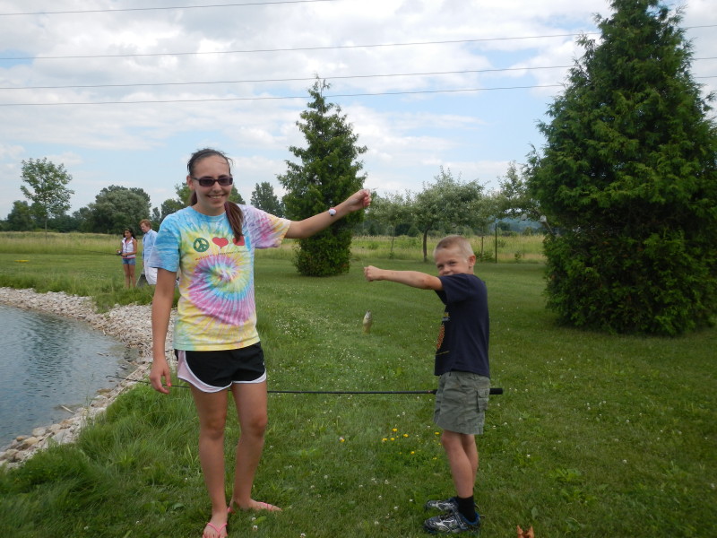 Ashley Abts helps young fisherman