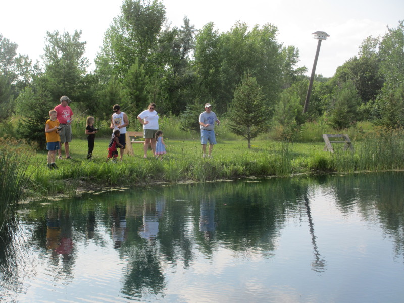 A group of fisherfolk trying the larger pond