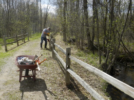 Doug Seidl fixing fence posts along trail