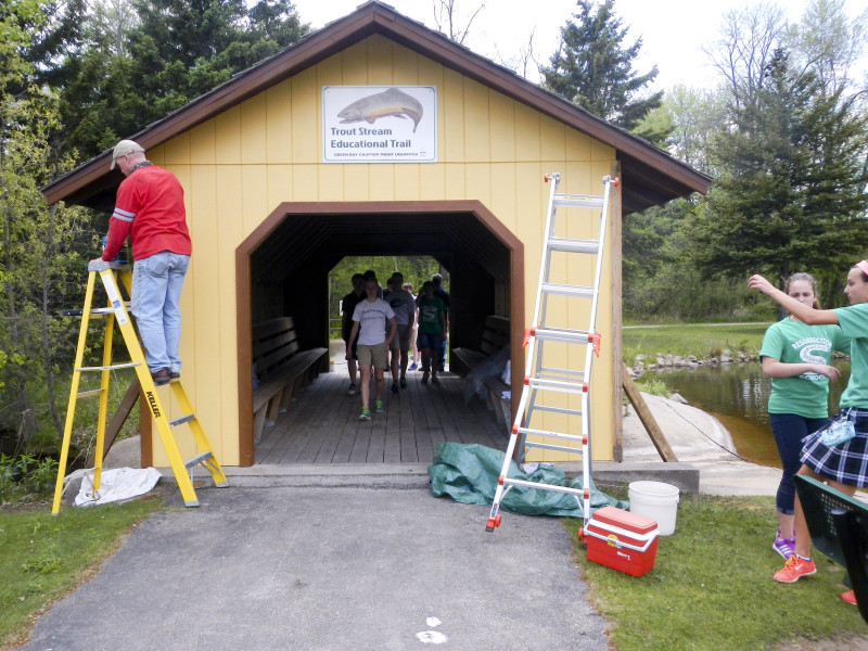 Mike Renish working on trim and around tour group